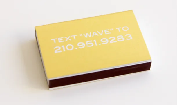 A gold-foil matchbook reads Text Wave to 210.951.9283.